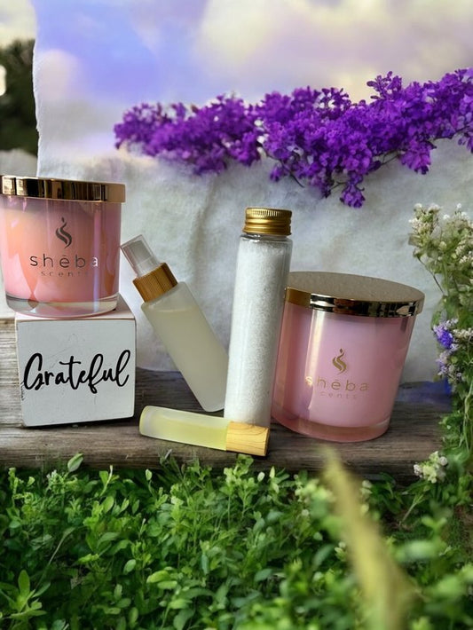 For Her  - Gift Bundle by Sheba Scents featuring Gratitude Candle, bath soak, pillow spray, and energize ro ll-on displayed together in a minimal luxury setting.
