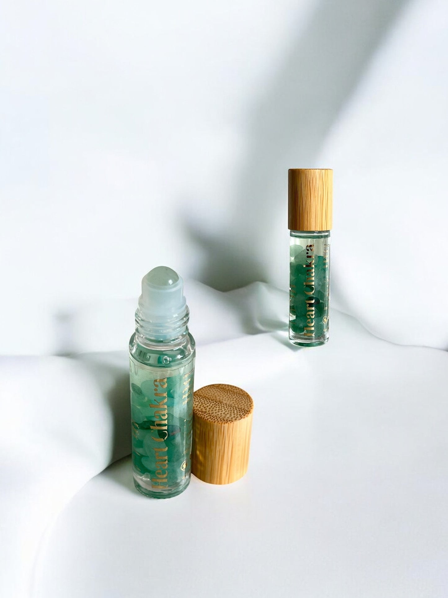 Sheba Scents Heart Chakra Essential Oil Roll-On packaging featuring toxin-free, handmade, crystal-infused aromatherapy blend for holistic wellness.
