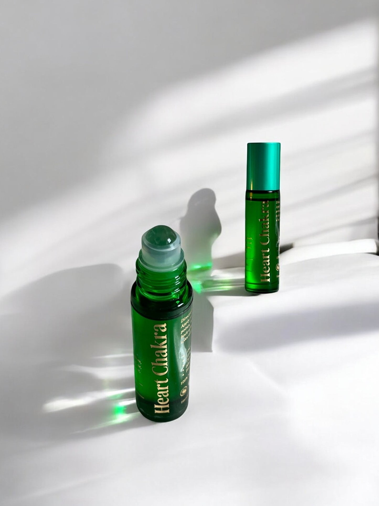 Sheba Scents Heart Chakra Essential Oil Roll-On with green adventurine crystal roller, ideal for meditation, reiki, yoga, and spiritual wellness.