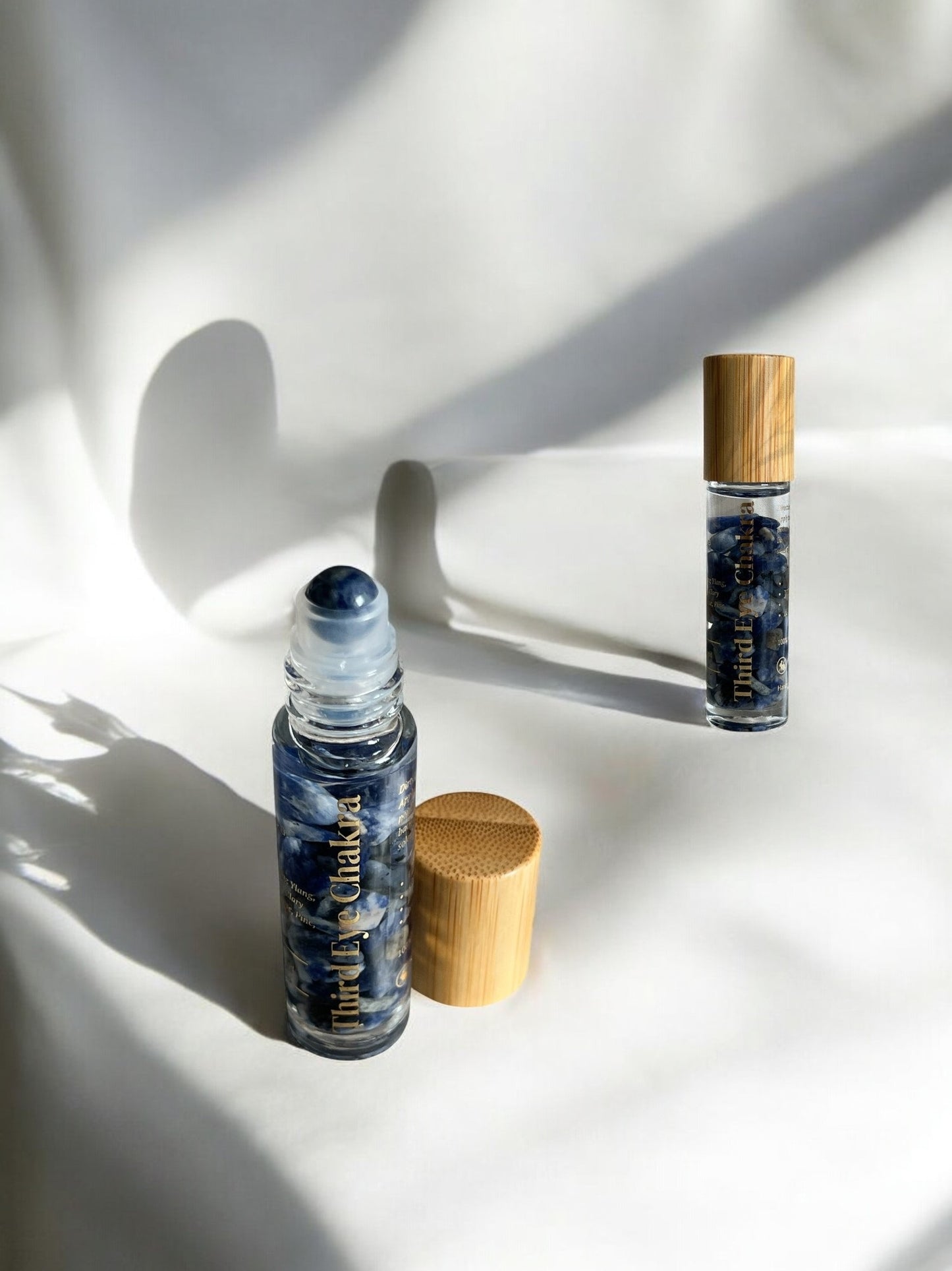 10ml clear glass bottle infused with lapis lazuli crystals and roller ball for Third Eye Chakra healing and spiritual insight