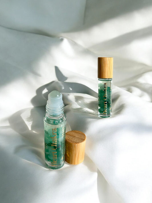 Close-up of Sheba Scents Heart Chakra Essential Oil Roll-On applying aromatherapy blend for chakra balancing, emotional support, and self-care rituals.