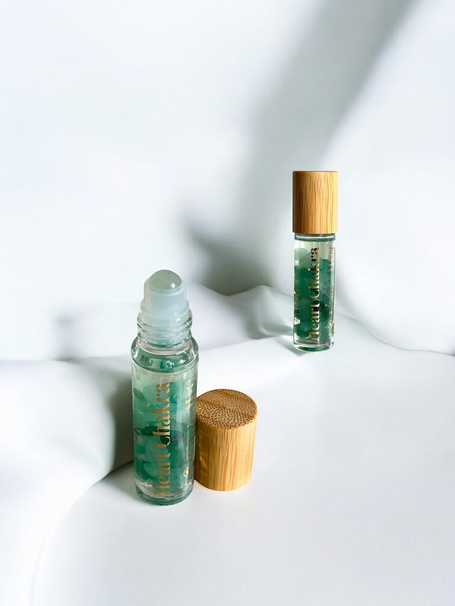 Sheba Scents Heart Chakra Essential Oil Roll-On packaging featuring toxin-free, handmade, crystal-infused aromatherapy blend for holistic wellness.
