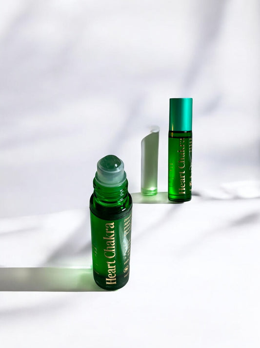 Sheba Scents Heart Chakra Essential Oil Roll-On with green heart chakra bottle and green aventurine crystal roller ball for love, balance, and emotional healing.