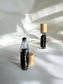 Sheba Scents Root Chakra Essential Oil Roll-On with black obsidian crystals ideal for meditation, reiki, yoga, grounding, and spiritual healing.