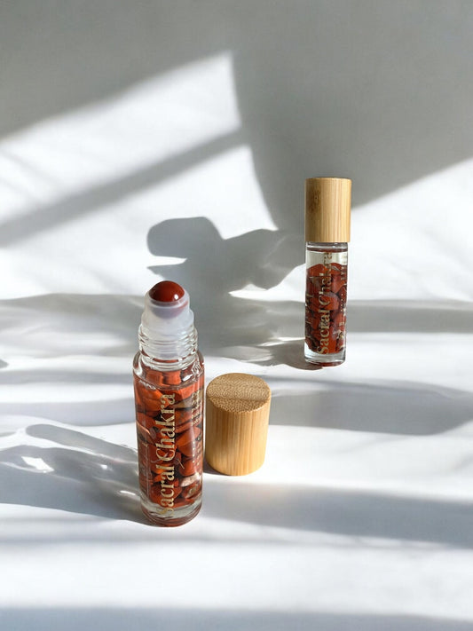 Sheba Scents Sacral Chakra Roll-On featuring red jasper crystal filled bottle, designed for passion, wellness, emotional balance, and sacral chakra healing.
