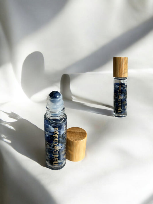 10ml clear glass bottle infused with lapis lazuli crystals and roller ball for Third Eye Chakra healing and spiritual insight