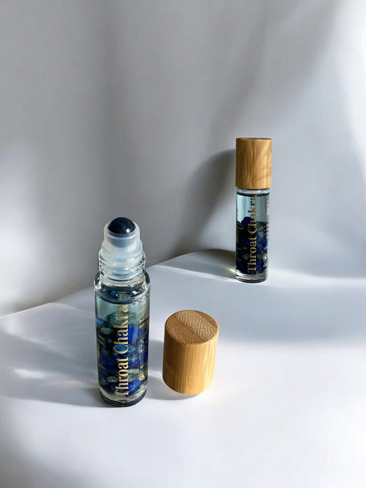 Crystal-infused Throat Chakra Oil with clear glass and sodalite crystals inside handmade by Sheba Scents